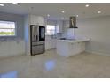 Modern kitchen featuring stainless steel appliances and white cabinets at 1732 Boca Raton Ct, Punta Gorda, FL 33950