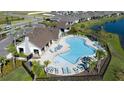 Community pool with lounge chairs and a clubhouse at 12513 Oak Hill Way, Parrish, FL 34219