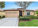 Charming single-story home featuring a two-car garage, tiled roof, and well-manicured front yard at 340 Cedar Falls Dr, Apollo Beach, FL 33572