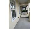 Front porch with white bench and potted plants at 4707 Woodbrook Dr, Sarasota, FL 34243