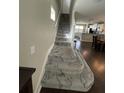 Staircase with patterned carpet runner leading to upper level at 4707 Woodbrook Dr, Sarasota, FL 34243