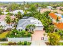 Aerial view of a single-Gathering home with lush landscaping and a brick driveway at 1954 Datura St, Sarasota, FL 34239