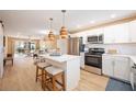 Bright kitchen with island, stainless steel appliances, and white cabinets at 2300 Stickney Point Rd Rd # 104, Sarasota, FL 34231