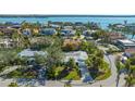 Aerial view of the home showcasing its location in a neighborhood surrounded by lush trees and water at 435 Partridge Cir, Sarasota, FL 34236