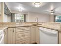 Modern kitchen features granite countertops, light cabinets, and a built-in dishwasher at 850 S Tamiami Trl # 701, Sarasota, FL 34236