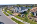 Community view showcasing a one-story house with a gray garage door at 13005 Rinella St, Venice, FL 34293