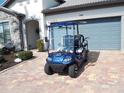 Blue golf cart with white and blue striped seats at 13005 Rinella St, Venice, FL 34293