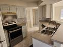 Kitchen features stainless steel appliances and a double sink at 25692 Aysen Dr, Punta Gorda, FL 33983