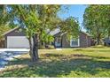 Gray house with a two-car garage and a well-maintained lawn at 4905 22Nd E Ct, Bradenton, FL 34203