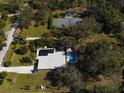 Aerial view of home, pool, tennis court, and guest house at 2910 49Th St, Sarasota, FL 34234