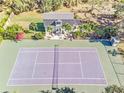 Aerial view showing home, tennis court, and lush landscaping at 2910 49Th St, Sarasota, FL 34234