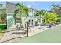 Light green house exterior with patio and palm trees at 2910 49Th St, Sarasota, FL 34234