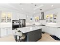 Spacious kitchen featuring white cabinets, stainless steel appliances, and an island at 9908 Carnoustie Pl, Bradenton, FL 34211