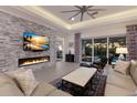 Spacious living room showcasing a modern fireplace and plenty of natural light at 9908 Carnoustie Pl, Bradenton, FL 34211