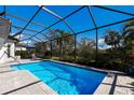 Refreshing pool with screened enclosure and ample deck space at 9908 Carnoustie Pl, Bradenton, FL 34211