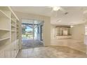 Bright breakfast nook with built-in shelving and pool view at 10643 Old Grove Cir, Bradenton, FL 34212