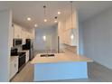 Modern kitchen featuring white cabinets, quartz countertops, and stainless steel appliances at 16105 Old Fox Trl, Port Charlotte, FL 33953