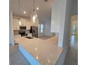 Modern kitchen island with white cabinets and quartz countertops at 16105 Old Fox Trl, Port Charlotte, FL 33953