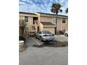 Tan condo building with stairs and parking at 6312 7Th W Ave # 6312, Bradenton, FL 34209