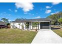 Newly renovated single-story home with driveway and landscaping at 7555 Hanchey St, North Port, FL 34287