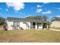 Newly renovated single-story home with driveway and landscaping at 7555 Hanchey St, North Port, FL 34287