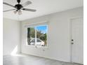 Bright living room with vinyl flooring and a large window at 7555 Hanchey St, North Port, FL 34287