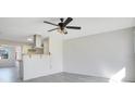 Bright and spacious living room with grey vinyl flooring and ceiling fan at 7555 Hanchey St, North Port, FL 34287