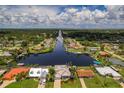 Wide aerial showcasing waterfront homes, lush greenery, and a peaceful canal at 4440 Tatum St, Port Charlotte, FL 33948