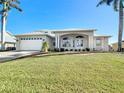 Inviting exterior of a two-story home with a well-maintained lawn at 4440 Tatum St, Port Charlotte, FL 33948