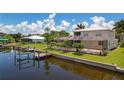 Waterfront home showcasing pool, dock, and canal views at 4440 Tatum St, Port Charlotte, FL 33948