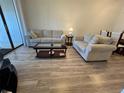 Bright living room featuring neutral-toned furniture and wood-look flooring at 4320 47Th W Ave # 203, Bradenton, FL 34210