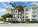 Three-story condo building with palm trees and balconies at 7840 34Th W Ave # 103, Bradenton, FL 34209