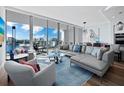 Modern living room featuring a comfy sectional sofa and city views at 1155 N Gulfstream Ave # 703, Sarasota, FL 34236