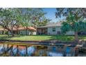 House back view, overlooking a canal with lush landscaping at 128 51St Street E Cir # 7, Palmetto, FL 34221