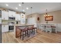 Modern kitchen with island, white cabinets, and hardwood floors at 128 51St Street E Cir # 7, Palmetto, FL 34221