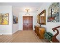 Inviting foyer with hardwood floors, a decorative mirror, and a grand double-door entry at 401 Walls Way, Osprey, FL 34229