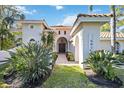 Charming front entrance with brick walkway and well-maintained tropical landscaping at 401 Walls Way, Osprey, FL 34229