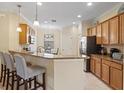 Modern kitchen with granite countertops and stainless steel appliances at 6870 Willowshire Way, Bradenton, FL 34212