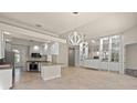 Modern kitchen with white cabinets, stainless steel appliances, and a large island at 5762 Benevento Dr, Sarasota, FL 34238
