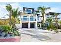 Two-story home with two-car garage and tropical landscaping at 551 S Washington Dr, Sarasota, FL 34236