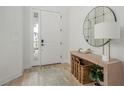 Bright and airy foyer with wood floors, console table, and a large mirror at 5554 Sand Fossil Ct, Sarasota, FL 34238