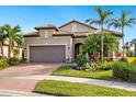 Single-story home with two-car garage and landscaping at 5987 Snowy Egret Dr, Sarasota, FL 34238