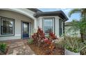 Front entry with blue door and brick walkway at 6839 Chester Trl, Bradenton, FL 34202