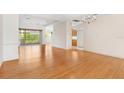 Bright dining room with hardwood floors and a view into the kitchen at 9143 Willow Brook Dr, Sarasota, FL 34238