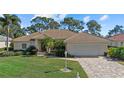 One-story home with tile roof, landscaped yard, and two-car garage at 8111 Fairhaven Glen, University Park, FL 34201