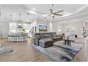 Spacious living room with a sectional sofa, large TV, and access to the patio at 13021 Indigo Way, Bradenton, FL 34211