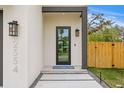 Modern front entry with glass door and stone walkway at 2554 Arlington St, Sarasota, FL 34239