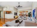 Spacious living room featuring hardwood floors, a ceiling fan, neutral tones, and access to an outdoor patio at 6600 Deering Cir, Sarasota, FL 34240