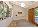 Light and airy entryway with polished concrete floors and modern art at 4844 Brywill Cir, Sarasota, FL 34234