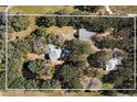 Aerial view showing home, pool, and outbuildings on the property at 7146 Territory Ln, Sarasota, FL 34240